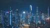 Aerial drone fly‑by video of the Guangzhou skyline at night, featuring Canton Tower and the two Guangzhou Twin Towers - the Guangzhou CTF Finance Centre and the Guangzhou International Finance Center (IFC) - illuminated in blue.