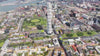 Aerial drone video of the Turning Torso skyscraper in Västra Hamnen with Malmö, Sweden, in the background, on a sunny summer day.